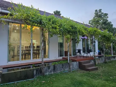 a house with a pergola with vines on it at Naiharn Beach Holiday Villa 2, Rawai Phuket in Rawai Beach