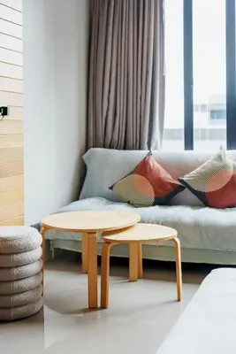 a living room with a couch and two tables at 405 Relife 5 Minutes Walk To Nai Harn Beach in Rawai Beach