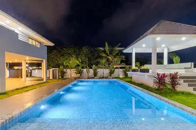 a swimming pool in the backyard of a house at night at 4BR Big Pool 2 Villas Same Land Near Nai Harn V258 in Rawai Beach