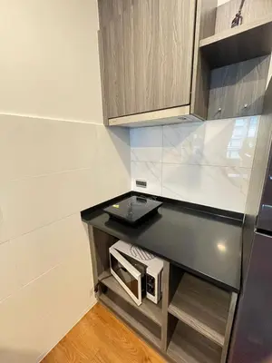 a kitchen with a counter with a microwave in it at The Central Escape Phuket in Ban Rangeng