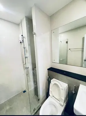 a bathroom with a shower and a toilet and a sink at The Central Escape Phuket in Ban Rangeng