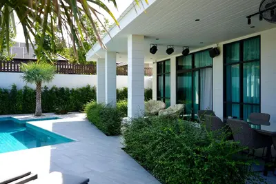 a house with a patio and a swimming pool at Villa Sofia in Ban Phak Chit