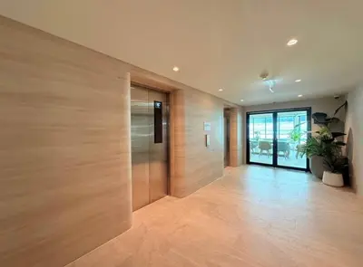 a hallway with wooden walls and a door with a plant at Boat Avenue Modern Loft in Ban Thalat Choeng Thale