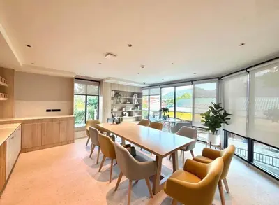 a kitchen and dining room with a table and chairs at Boat Avenue Modern Loft in Ban Thalat Choeng Thale