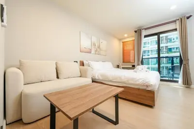 a living room with a couch and a bed at Boat Avenue Modern Loft in Ban Thalat Choeng Thale