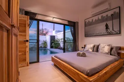 a bedroom with a bed and a large window at Luxury 3 bed villa with private pool, Rawai Phuket in Rawai Beach