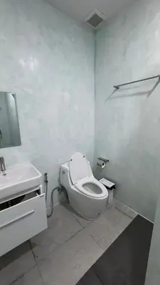 a white bathroom with a toilet and a sink at Bang Jo Garden Home in Koh Lone