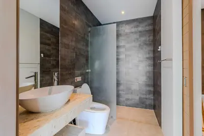 a bathroom with a large sink and a toilet at V259 Great for Relaxing with Pool & Full Amenities in Thalang
