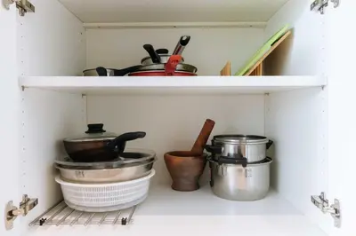a shelf with pots and pans in a kitchen at V259 Great for Relaxing with Pool & Full Amenities in Thalang