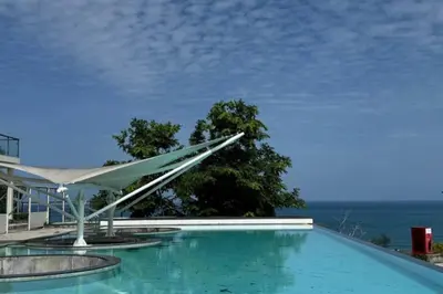 a swimming pool with a view of the ocean at Utopia Karon Sea View Apartments in Karon Beach