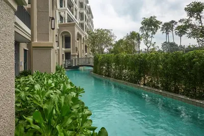 a swimming pool in the middle of a building at Title Legendary Bang Tao by My Home Phuket in Ban Nong Chaeng