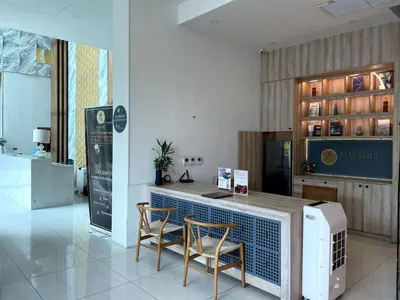 a kitchen with a counter with two chairs and a table at Modern condo with full sea view, 4 min walk to Kamala beach in Kamala Beach