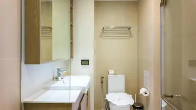 a bathroom with a sink and a toilet and a mirror at Стильные апартаменты с террасой in Laguna Phuket