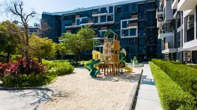 a playground in front of a apartment building at Стильные апартаменты с террасой in Laguna Phuket