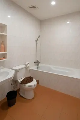 a bathroom with a toilet and a bath tub at Nova Patong in Patong Beach