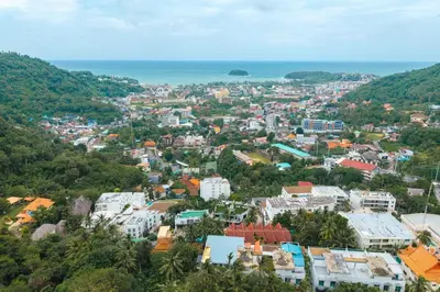 an aerial view of a city with buildings and the ocean at Kata Beach Tropical Hillside Retreat Jungle View in Kata Beach