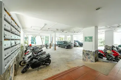 a garage with a bunch of motorcycles parked in it at Kata Beach Tropical Hillside Retreat Jungle View in Kata Beach