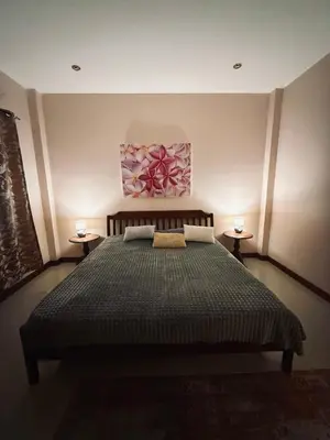 a bedroom with a bed and two lamps on two tables at Cozy family cottage w pool Bang Tao in Phuket