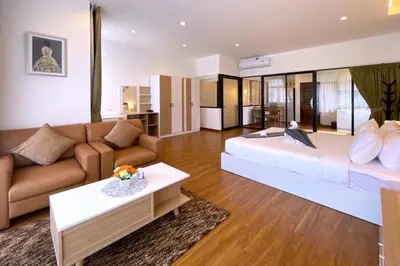 a living room with a large bed and a couch at Goldena Twin Private Villas - Duplex Villa with Sauna, Kamala in Kamala Beach