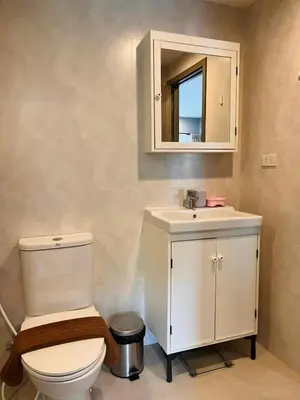 a bathroom with a toilet and a sink and a mirror at Comfy studio - 10 min walk to NaiYang Beach in Nai Yang Beach