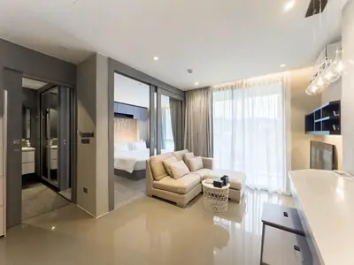 a living room with a couch and a bed at Citygate Apartament in Kamala Beach