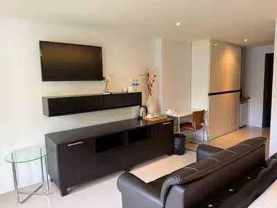 a living room with a couch and a flat screen tv at Studio apartment in Patong, Phuket in Patong Beach