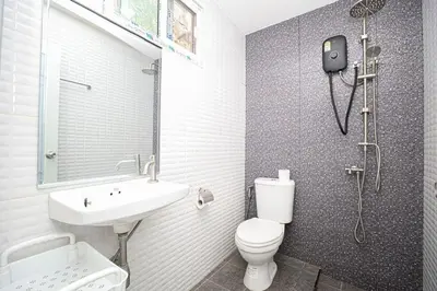 a bathroom with a toilet and a sink and a shower at GA-GA-GA A cozy house in a quiet location on Bang Tao Beach in Ban Thalat Choeng Thale