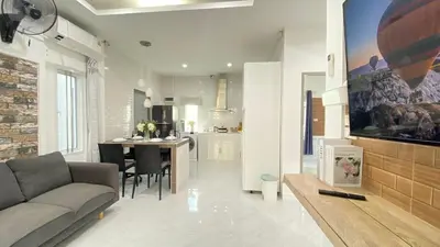 a living room and kitchen with a couch and a table at Cozy 2-bedrooms houses complex DIN, Bang Tao beach in Ban Thalat Choeng Thale