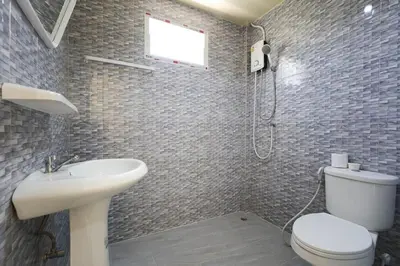 a bathroom with a toilet and a sink and a shower at Yellow apartments 46,47 in Ban Thalat Choeng Thale