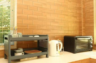 a kitchen counter with a microwave and a toaster oven at Yellow apartments 46,47 in Ban Thalat Choeng Thale