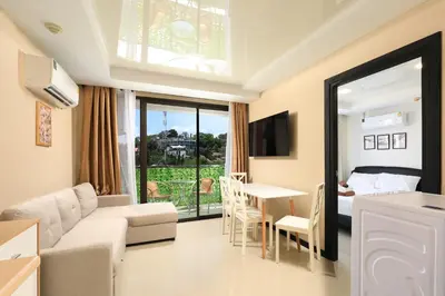 a living room with a couch and a table at Comfy 1-BR room Mountain View, 5 min to Rawai Beach in Phuket Town