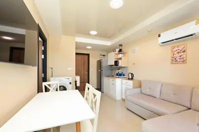a living room with a table and a couch at Comfy 1-BR room Mountain View, 5 min to Rawai Beach in Phuket Town