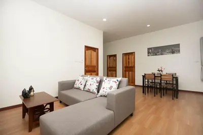 a living room with a couch and a table at 2 bedrooms house GREEN SALLY in Patong Beach