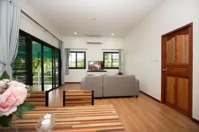 a living room with a couch and a table at 2 bedrooms house GREEN SALLY in Patong Beach