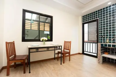 a dining room with a table and two chairs at Cat house, 5 min to the beach in Ban Thalat Choeng Thale
