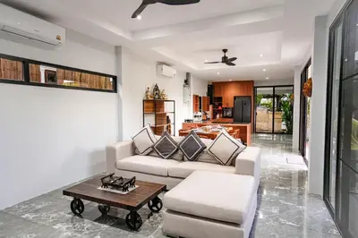 a living room with a couch and a table at Suwali Villa - 3 Bedroom Private Pool Villa in Ban Saiyuan (1)