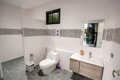 a bathroom with a toilet and a sink at Suwali Villa - 3 Bedroom Private Pool Villa in Ban Saiyuan (1)