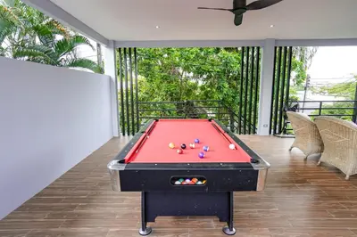a pool table in the middle of a room at Suwali Villa - 3 Bedroom Private Pool Villa in Ban Saiyuan (1)