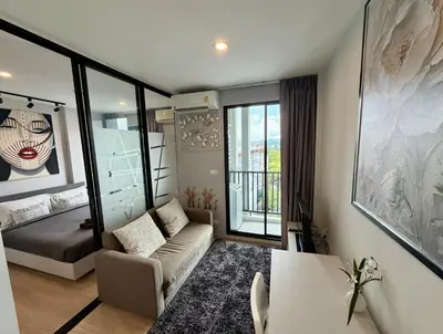 a small living room with a couch and a chair at Z cape 1 one one in Laguna Phuket