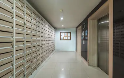 a walk in closet with wooden doors and tile floors at Z cape 1 two two in Ban Thalat Choeng Thale