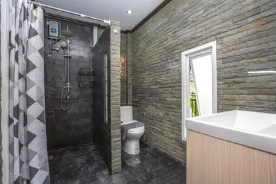 a bathroom with a shower and a toilet and a sink at Beautiful apartment in Ban Thalat Choeng Thale