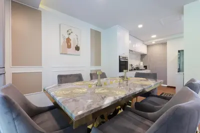 a dining room with a glass table and chairs at 3BR Pool Villa with Jacuzzi near Patong - 8 Guests in Kathu