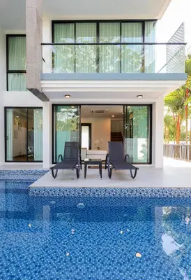 a house with a swimming pool in front of a house at 3BR Pool Villa with Jacuzzi near Patong - 8 Guests in Kathu
