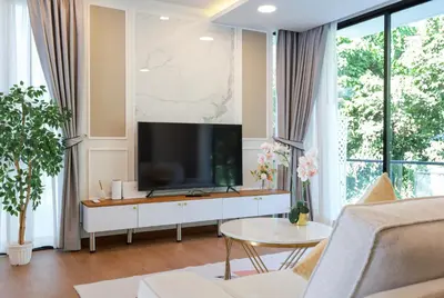 a living room with a flat screen tv on a white cabinet at 3BR Pool Villa with Jacuzzi near Patong - 8 Guests in Kathu
