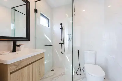 a bathroom with a shower and a toilet and a sink at 3BR Pool Villa with Jacuzzi near Patong - 8 Guests in Kathu