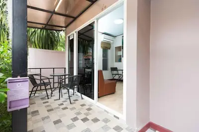 a balcony with a table and chairs in a building at KUM house in Laguna Phuket