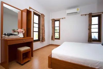 a bedroom with a bed and a dresser with a mirror at 