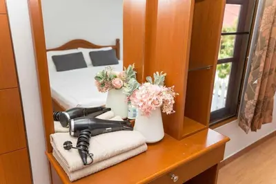 a bedroom with a mirror and a hair dryer on a table at 