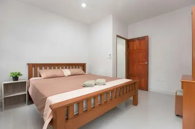 a bedroom with a large bed and a wooden cabinet at 