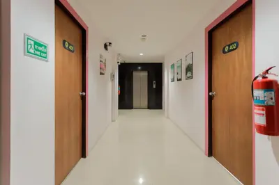 a corridor of a hospital with two doors and a fire extinguisher at sunflower \u4e00\u5367\u7cbe\u54c1\u5927\u5e8a\u623f\u5e26\u9633\u53f0 in Patong Beach